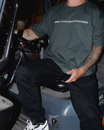 MAN WEARING A JOLLY ATHLETIC CLUB T SHIRT BY JOLLY CANNABIS. MEET YOUR HIGH STANDARDS. STAY JOLLY.